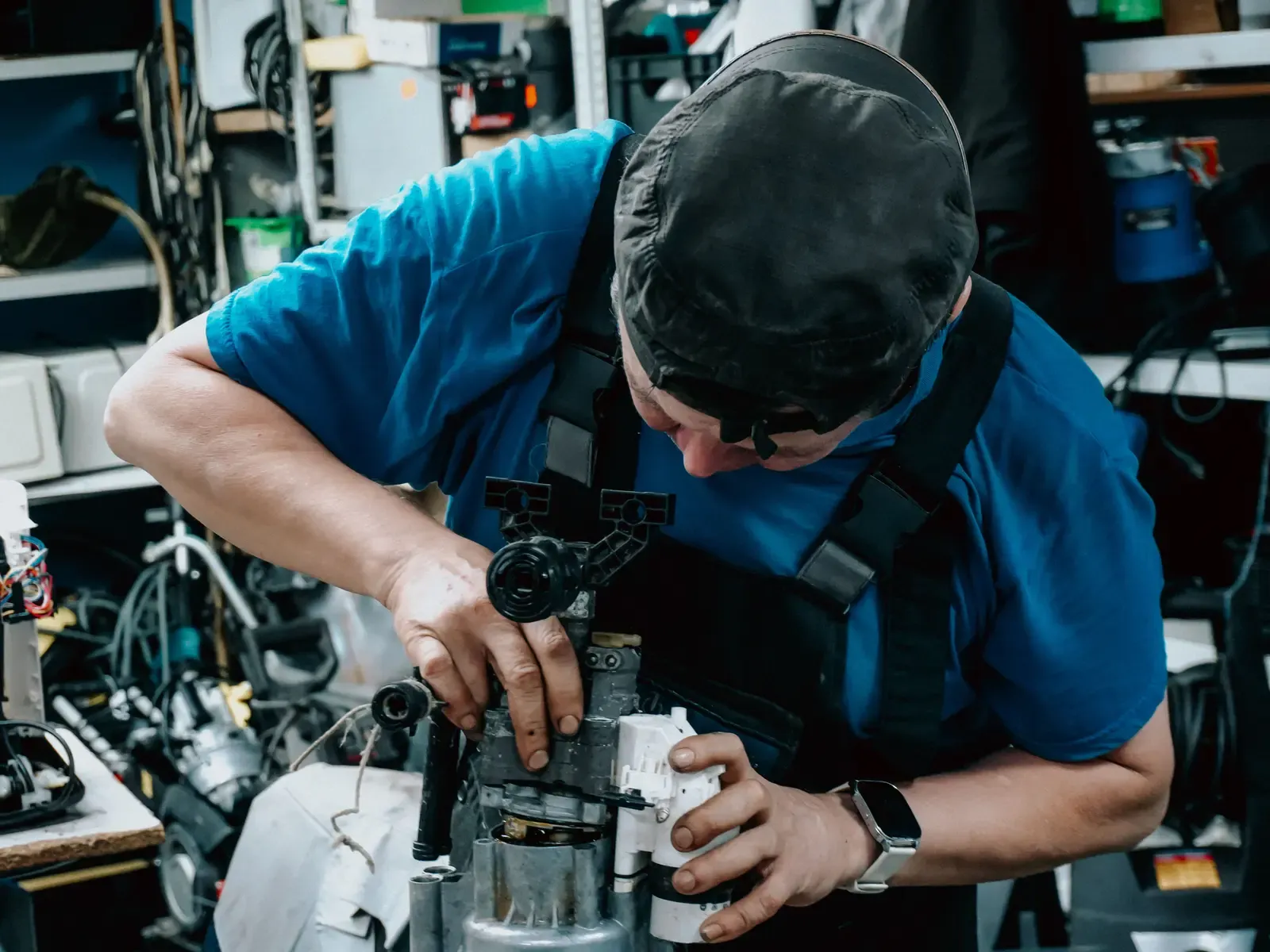 A Summit technician rebuilding a pump assembly at the shop workbench