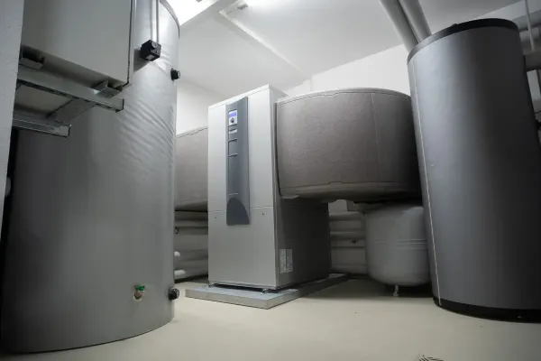 A high-efficiency heat pump and insulated buffer tanks in a home mechanical room